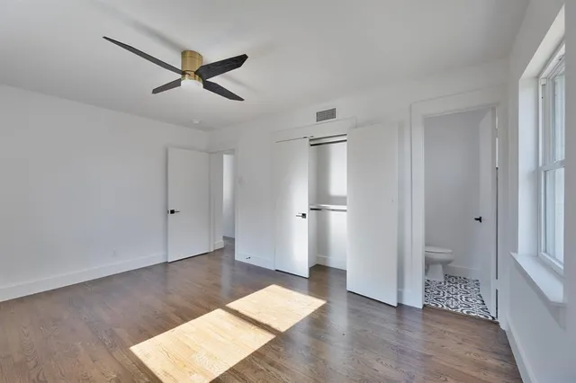 a view of an empty room and wooden floor