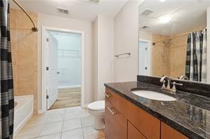 3300 Windy Ridge Parkway Southeast, Unit 913 Atlanta, GA 30339 - Photo 22 of 28 a bathroom with a granite countertop sink toilet and shower
