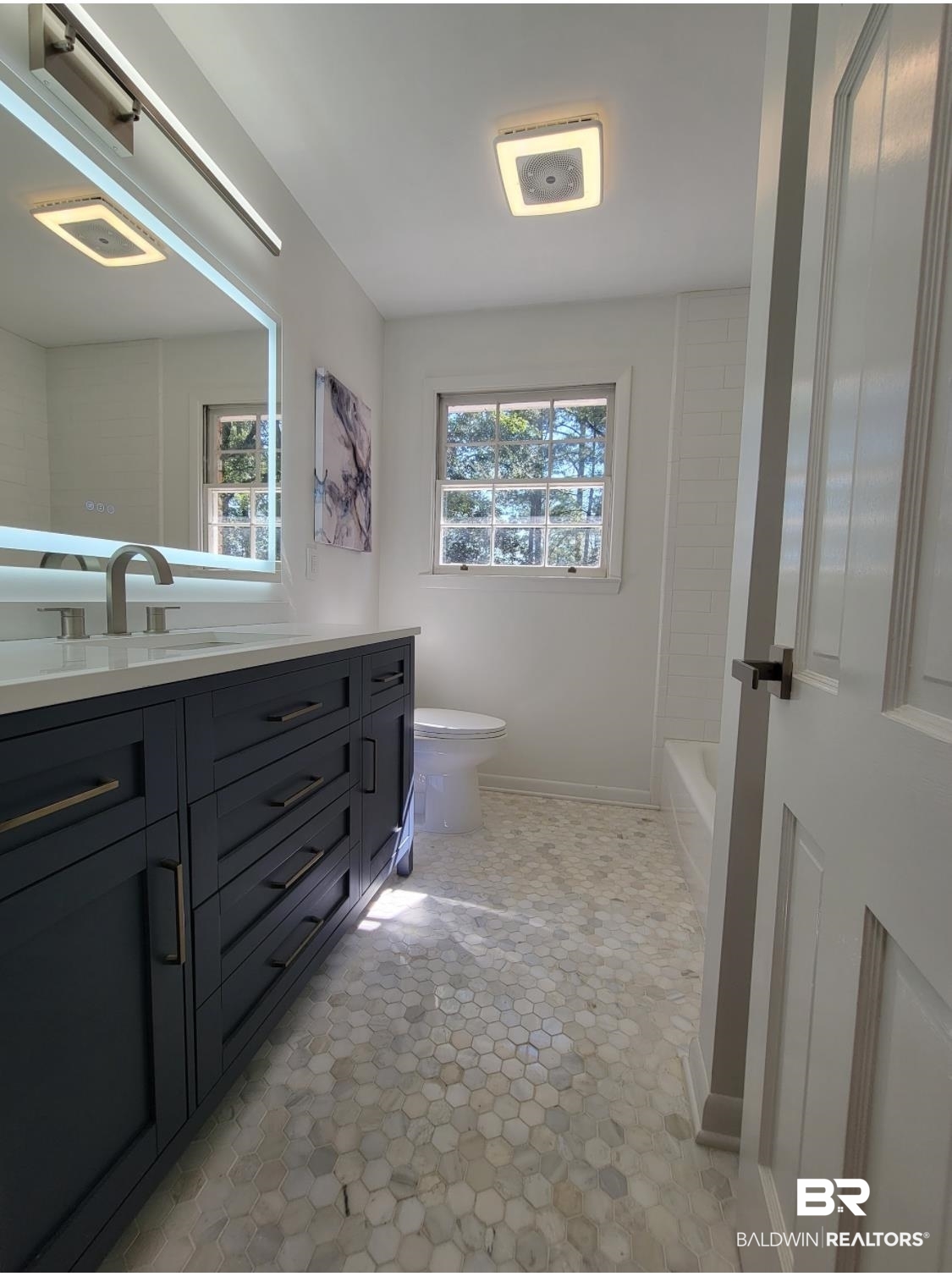159 Conway Drive West Mobile, AL 36608 - Photo 19 of 24 Full bath featuring vanity, plenty of natural light, light tile patterned flooring, and bathing tub / shower combination