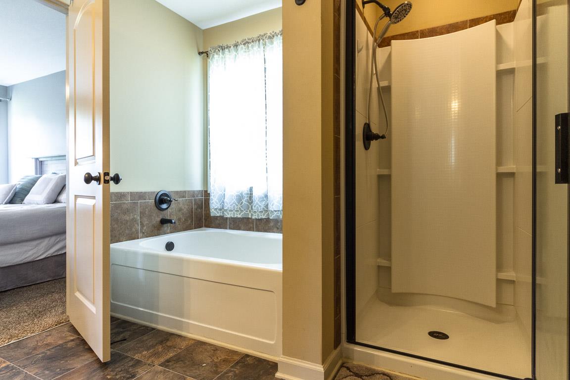 3752 Suiter Road Clarksville, TN 37040 - Photo 14 of 23 a bathroom with a tub and a shower
