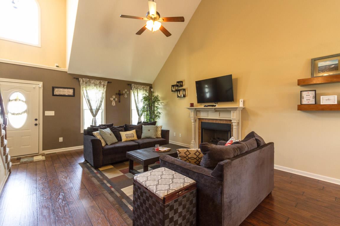 3752 Suiter Road Clarksville, TN 37040 - Photo 3 of 23 a living room with furniture a fireplace a flat screen tv and wooden floor