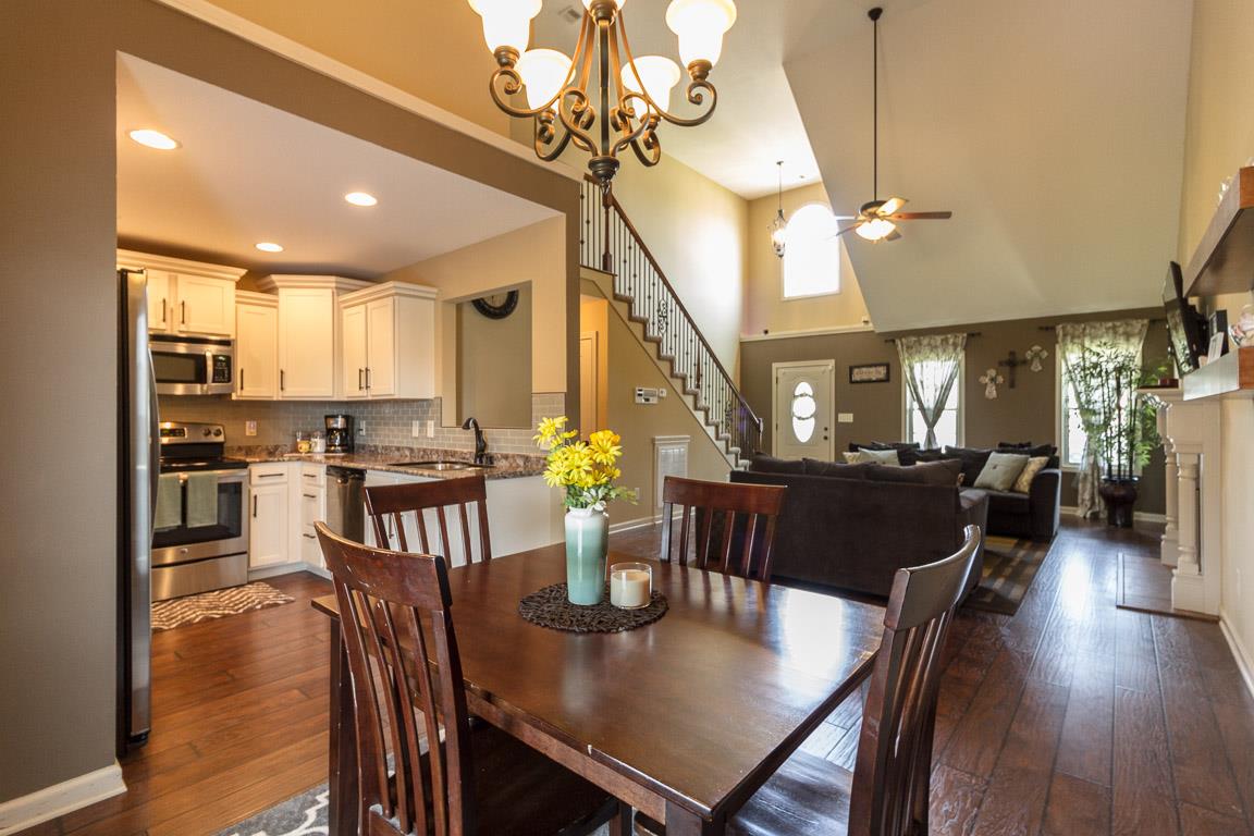 3752 Suiter Road Clarksville, TN 37040 - Photo 5 of 23 a view of a dining room and livingroom with furniture wooden floor a chandelier