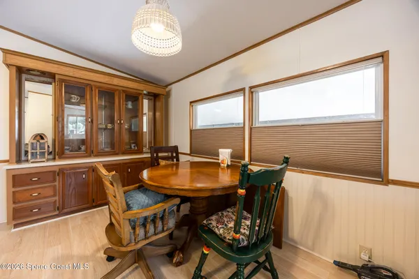 a view of a dining room with furniture and window