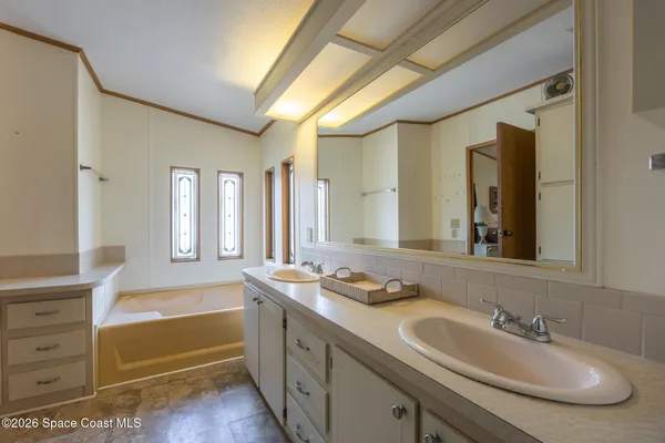 a bathroom with a granite countertop sink mirror and a toilet