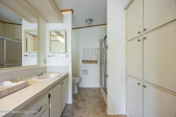 a bathroom with a glass shower door