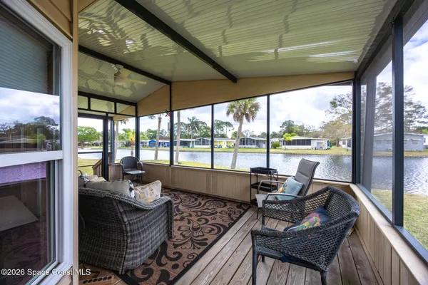 a living room with furniture and a floor to ceiling window