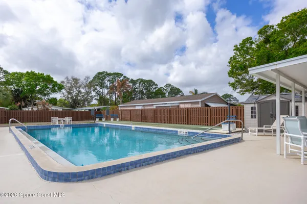 a view of a swimming pool with a lounge chair