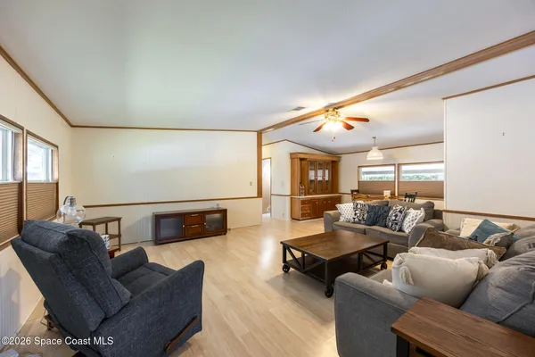 a dining room with furniture a rug and a large window