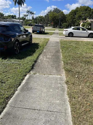 a view of a yard and car parked
