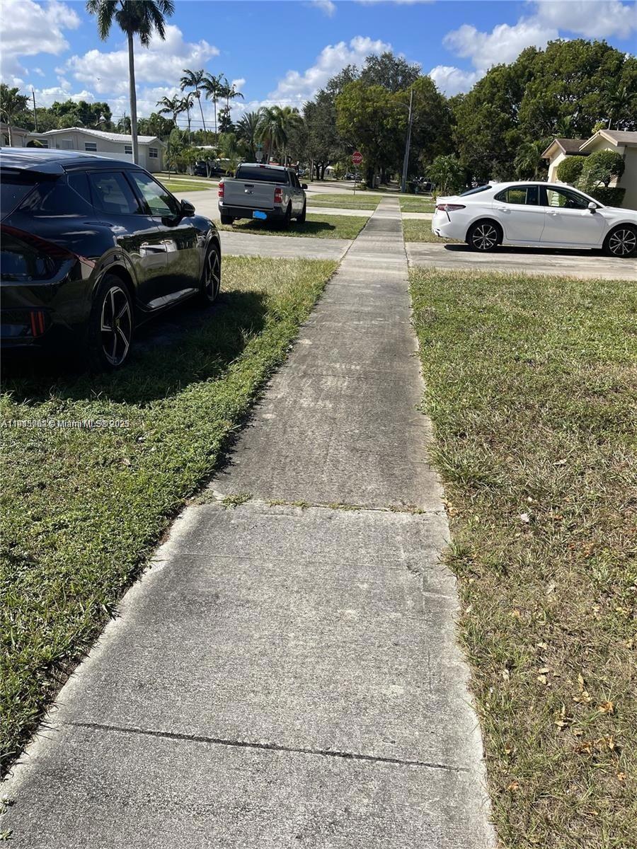 4315 Harrison Street Hollywood, FL 33021 - Photo 16 of 16 a view of a yard and car parked