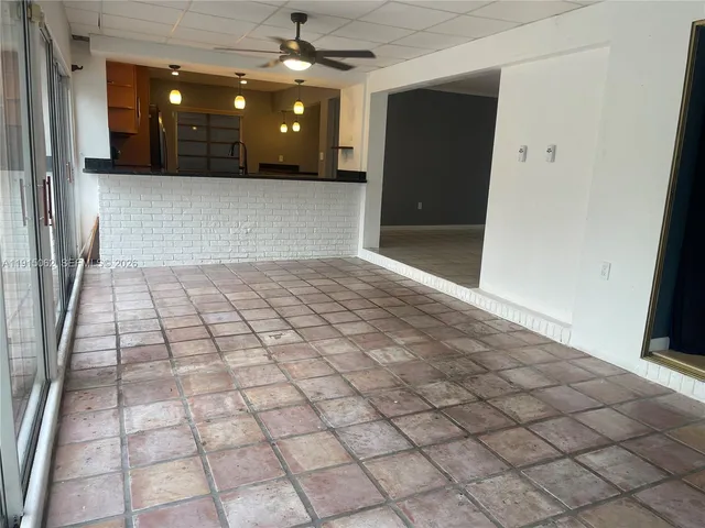 a view of a livingroom with furniture and a window