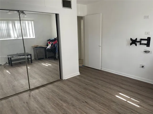 a bathroom with a toilet sink vanity and mirror