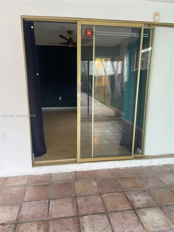 a view of a livingroom with a ceiling fan and window