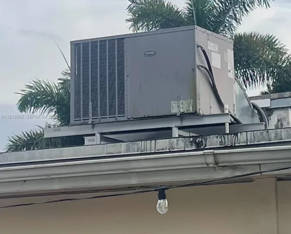 a white house that has a tree in front of it