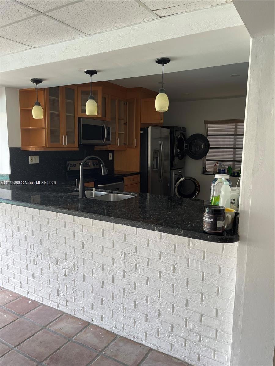 4315 Harrison Street Hollywood, FL 33021 - Photo 5 of 16 a kitchen with a refrigerator and a stove top oven