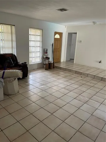a living room with a couch and a window