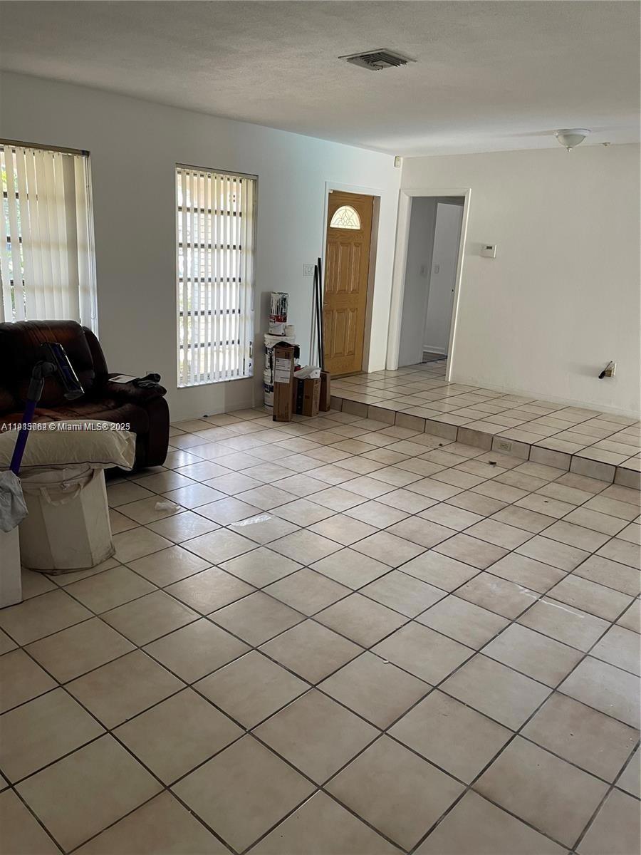 4315 Harrison Street Hollywood, FL 33021 - Photo 7 of 16 a living room with a couch and a window