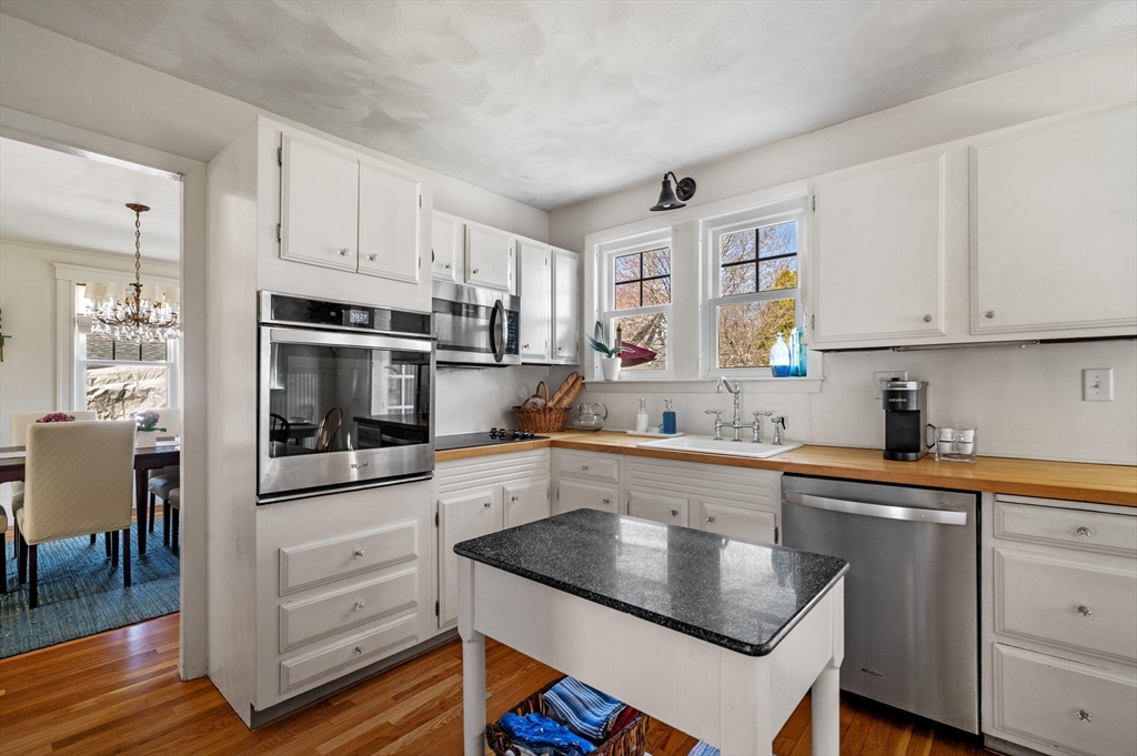 23 Tedesco Street Marblehead, MA 01945 - Photo 15 of 43 a kitchen with stainless steel appliances granite countertop a stove and white cabinets