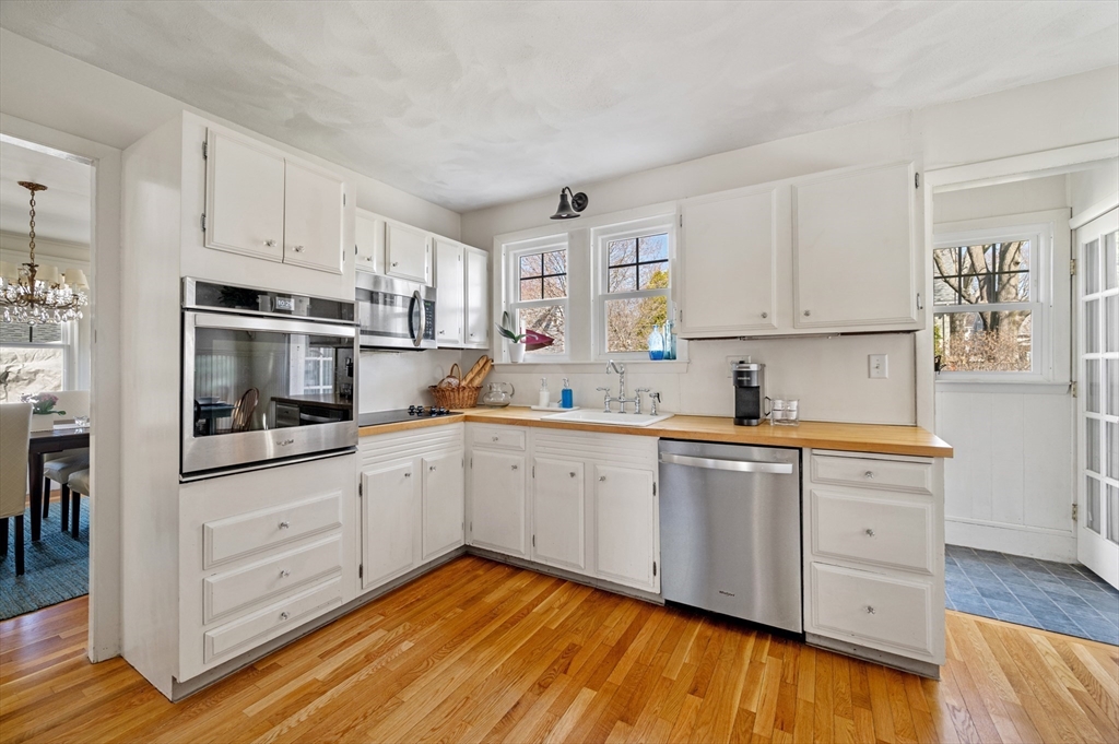23 Tedesco Street Marblehead, MA 01945 - Photo 16 of 43 a kitchen with granite countertop white cabinets and white appliances