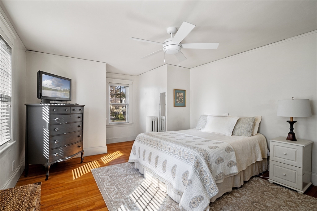 23 Tedesco Street Marblehead, MA 01945 - Photo 23 of 43 a bedroom with a bed and a chandelier