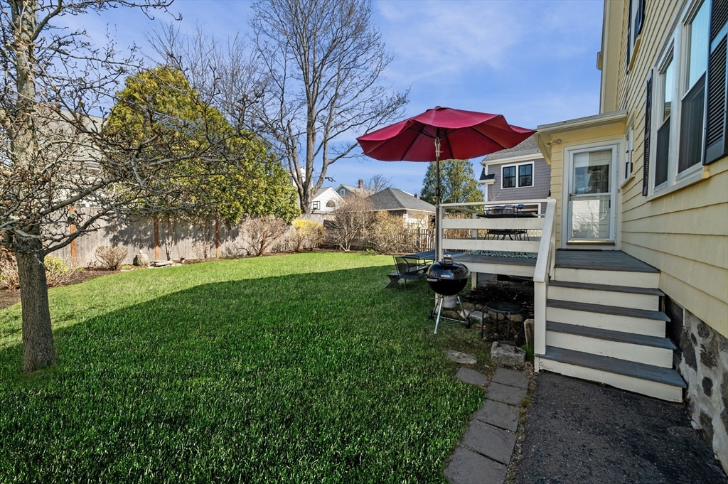 23 Tedesco Street Marblehead, MA 01945 - Photo 31 of 43 a view of a patio with a table and chairs under an umbrella