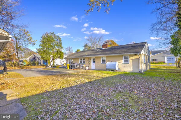 a front view of a house with a yard and swimming pool