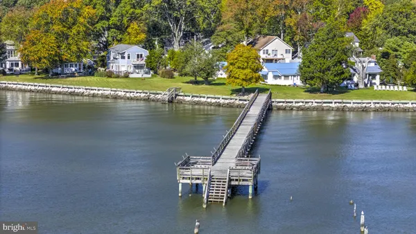 a view of a lake with a house sitting space and swimming pool