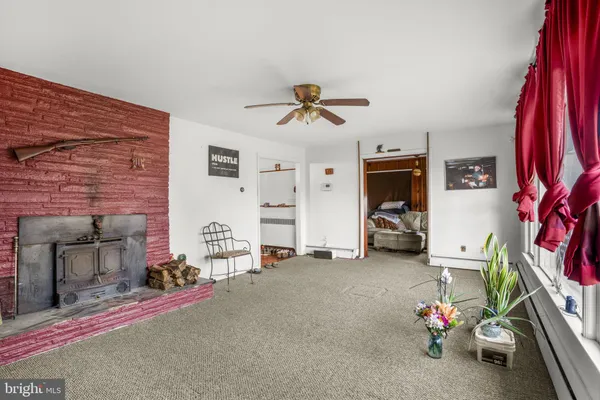 a view of a livingroom with furniture and a fan