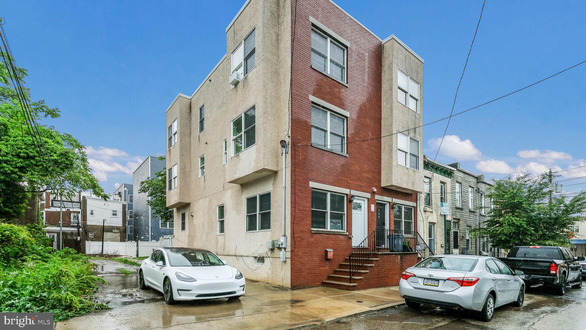 a car parked in front of a brick building