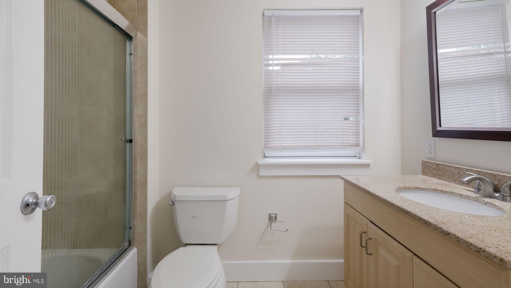 436 Sloan Street Philadelphia, PA 19104 - Photo 12 of 21 a bathroom with a granite countertop sink toilet and shower