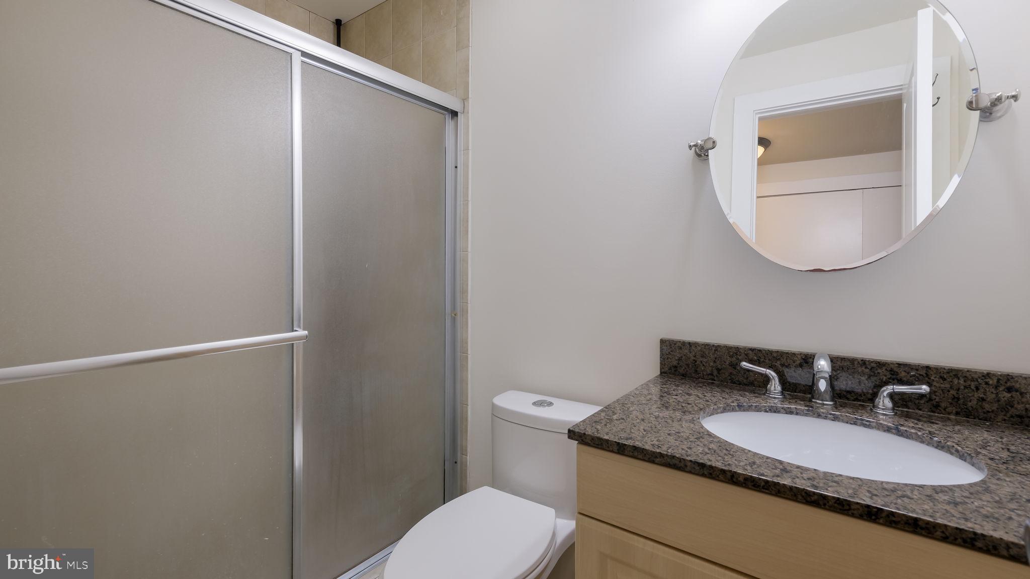 436 Sloan Street Philadelphia, PA 19104 - Photo 21 of 21 a bathroom with a granite countertop sink mirror vanity and toilet