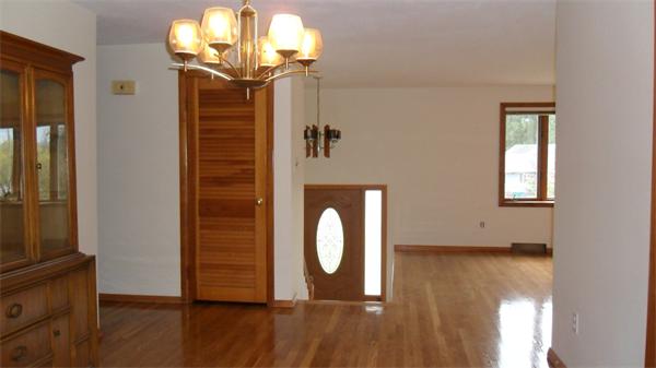7 Patricia Road Billerica, MA 01821 - Photo 4 of 18 a view of a livingroom with a wooden floor and a chandelier
