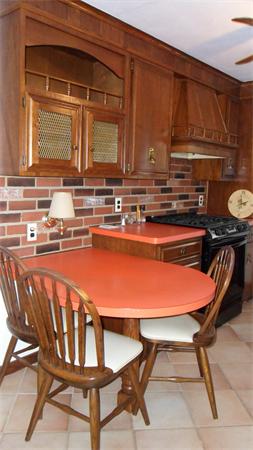 7 Patricia Road Billerica, MA 01821 - Photo 6 of 18 a kitchen with a stove a sink and a wooden cabinets