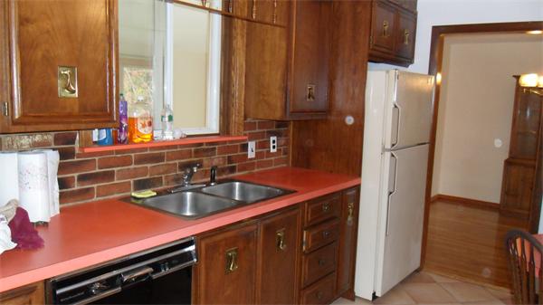 7 Patricia Road Billerica, MA 01821 - Photo 7 of 18 a kitchen with stainless steel appliances a sink and a refrigerator