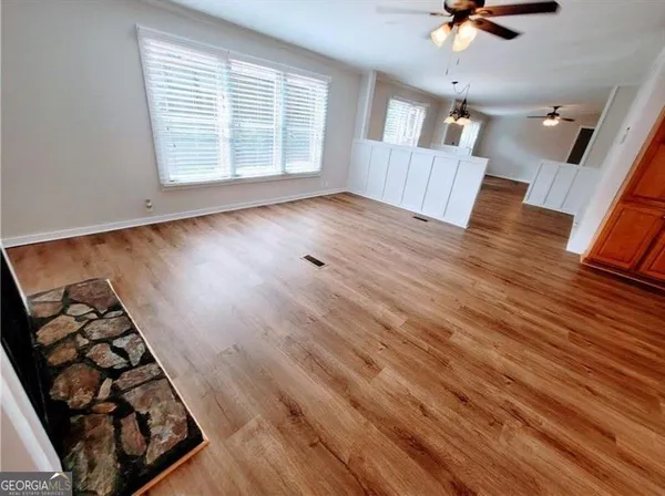 a view of a kitchen with cabinets and wooden floor