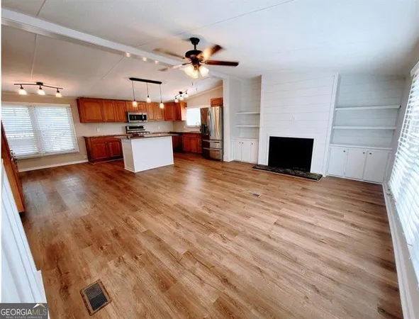 a kitchen with stainless steel appliances a stove a microwave and a refrigerator