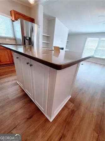 a kitchen with stainless steel appliances granite countertop a sink stove and wooden floor