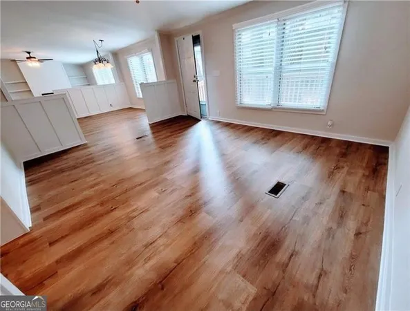 wooden floor in an empty room with a window