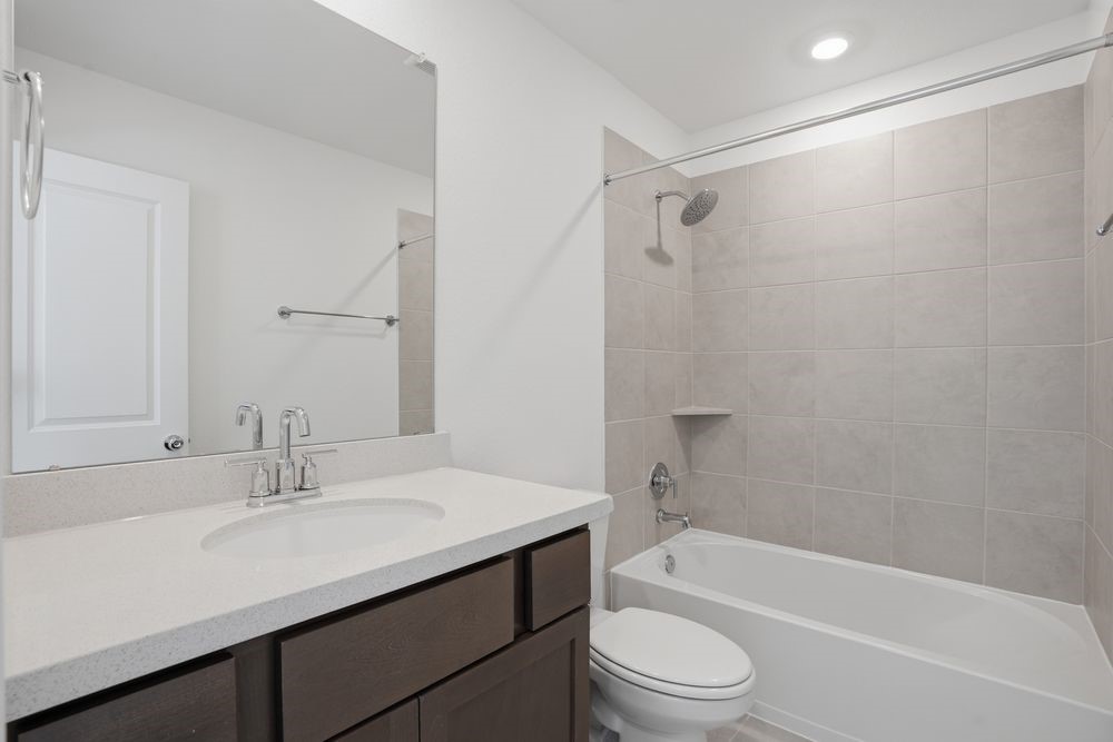 22122 Rangemore Drive Cypress, TX 77433 - Photo 12 of 28 a bathroom with a sink a toilet and a bathtub