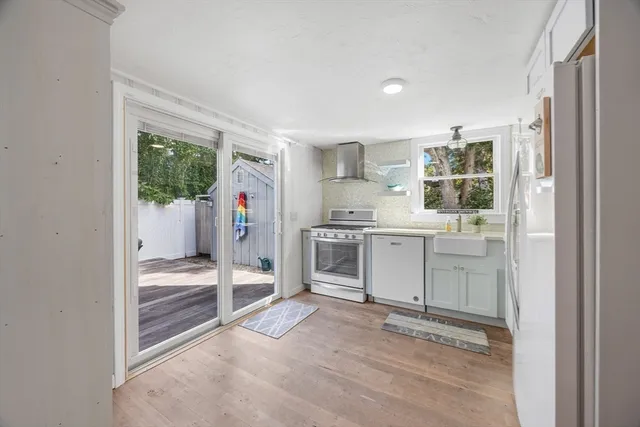 a kitchen with white cabinets and white appliances