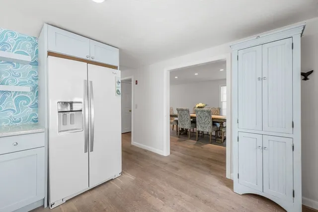 a view of kitchen with furniture and refrigerator