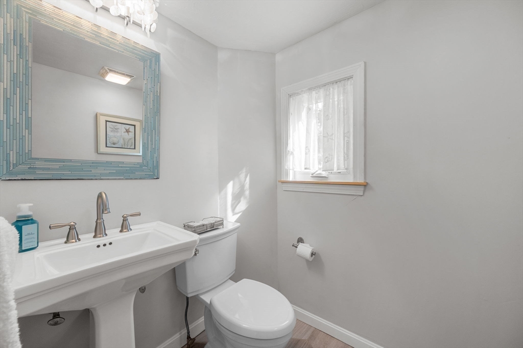 23 Zylpha Road Harwich, MA 02646 - Photo 17 of 39 a bathroom with a toilet a sink a mirror and a window