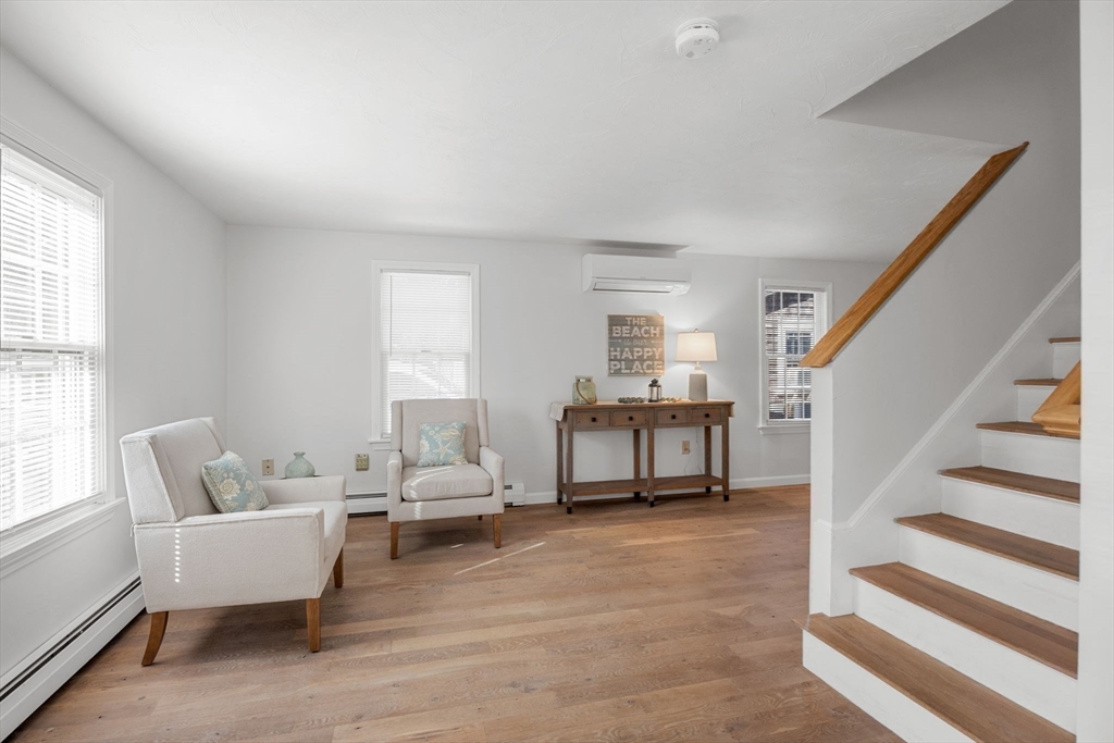 23 Zylpha Road Harwich, MA 02646 - Photo 18 of 39 a living room with furniture and a dining table with wooden floor