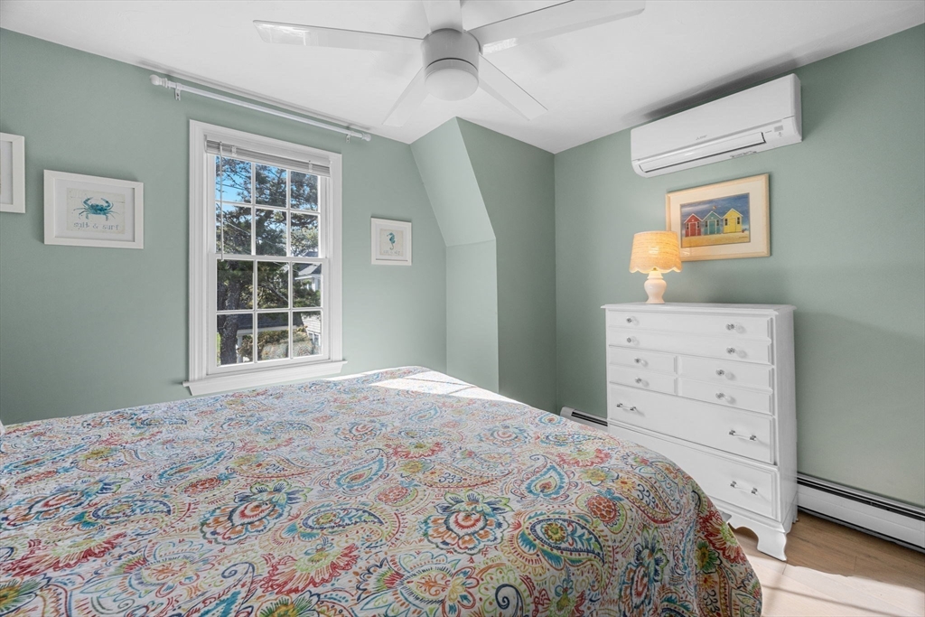 23 Zylpha Road Harwich, MA 02646 - Photo 23 of 39 a bedroom with a bed and a dresser next to a window