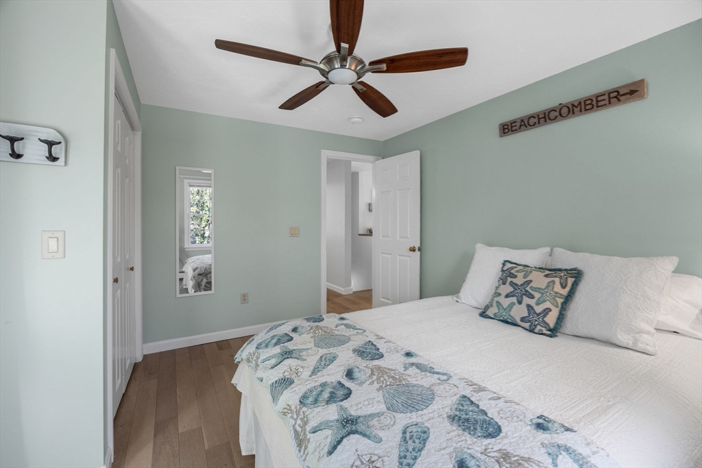 23 Zylpha Road Harwich, MA 02646 - Photo 26 of 39 a bedroom with a bed and a chandelier