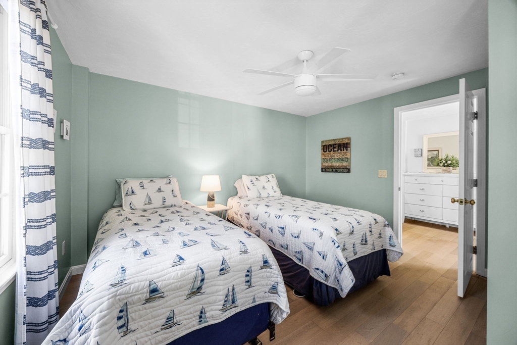 23 Zylpha Road Harwich, MA 02646 - Photo 27 of 39 a bedroom with two beds and a chandelier