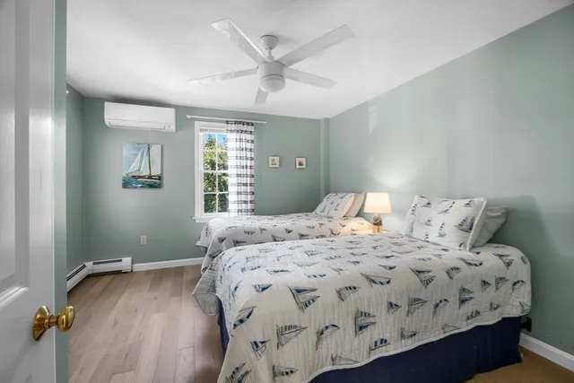a bedroom with a large bed chandelier and a window