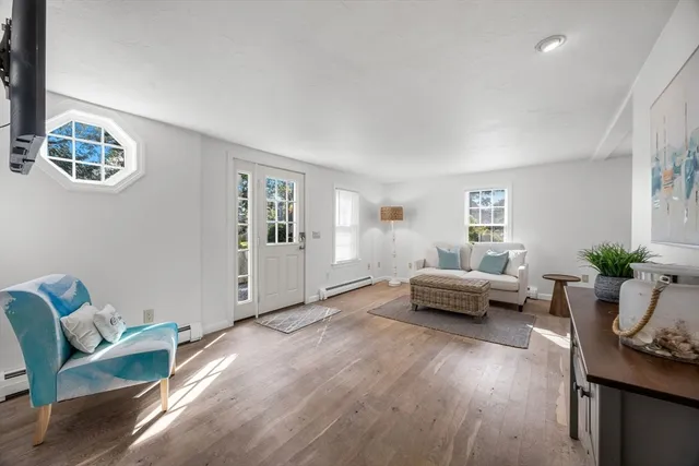 a living room with furniture and wooden floor