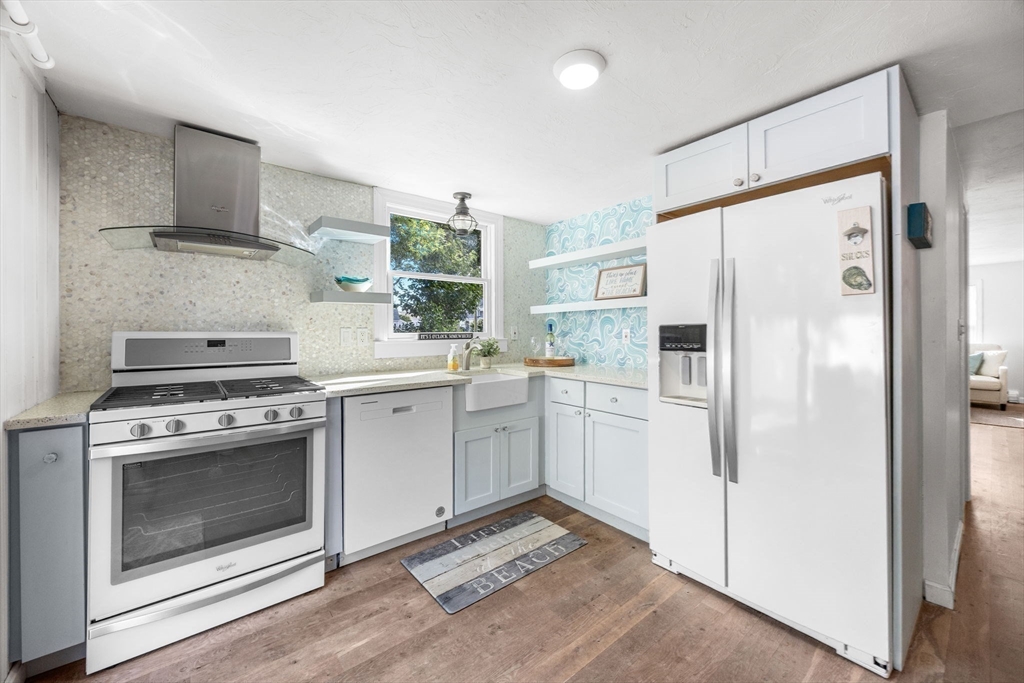 23 Zylpha Road Harwich, MA 02646 - Photo 10 of 39 a kitchen with white cabinets and white stainless steel appliances
