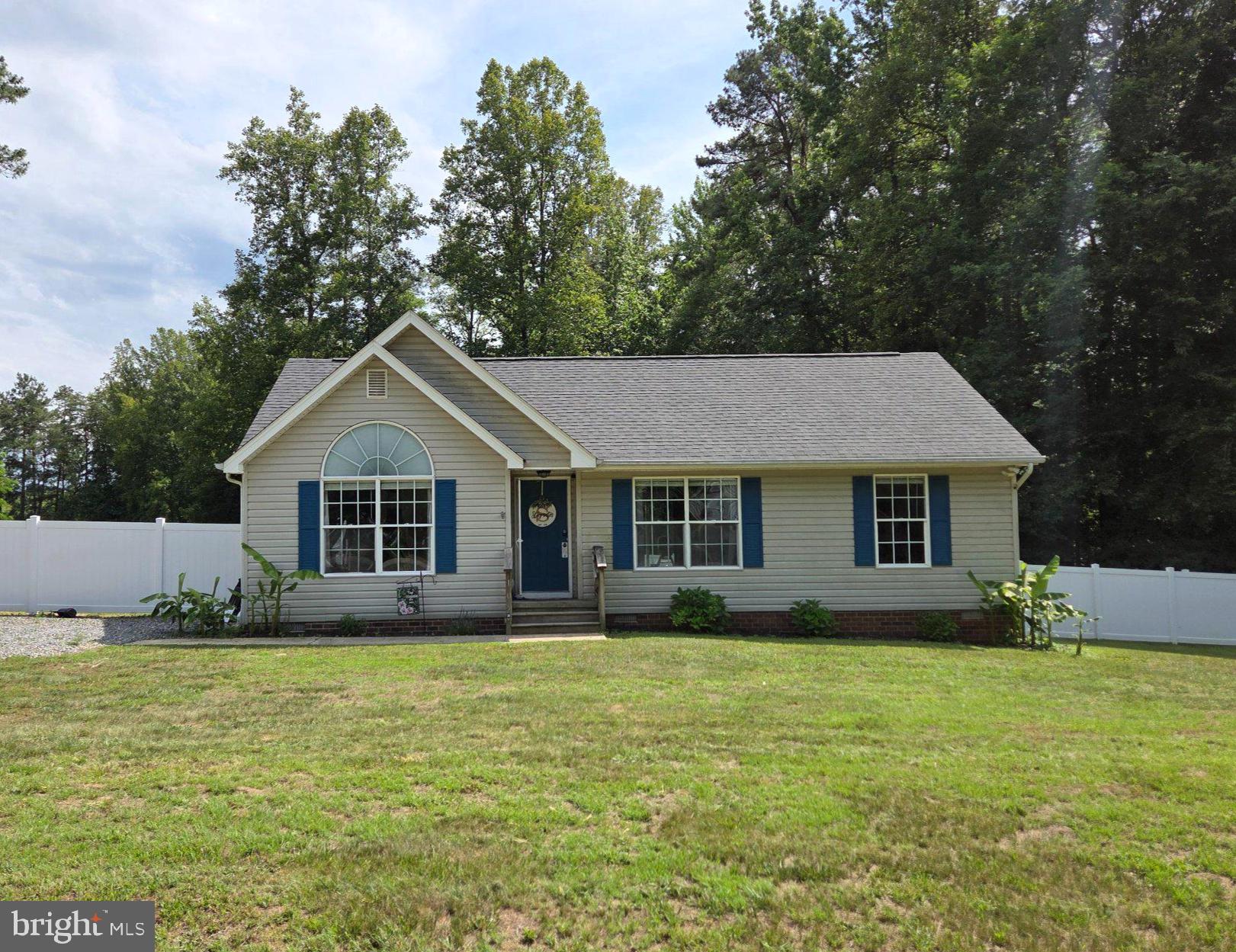 102 Independence Drive Ruther Glen, VA 22546 - Photo 1 of 1 Charming home with lush greenery backdrop.